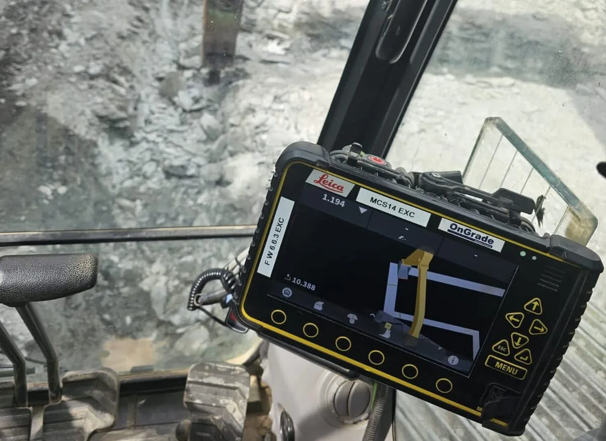 Machine control screen in an excavator cab, showing the bucket position against the design